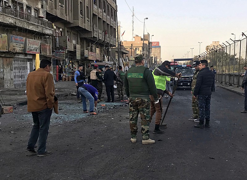 Iraqi security forces gather at the scene of a double suicide bombing in Baghdad, Iraq, Monday, Jan. 15, 2018. Interior Ministry spokesman said a double suicide bombing in central Baghdad has killed and wounded civilians. (AP Photo/Ali Abdul Hassan)