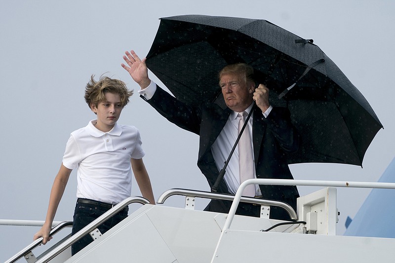 President Donald Trump and his son Barron board Air Force One at Palm Beach International Airport in West Palm Beach, Fla., Monday, Jan. 15, 2018, to travel to Washington. President Trump spent the holiday weekend at Mar-a-Lago, his club in Palm Beach, Fla. (AP Photo/Andrew Harnik)