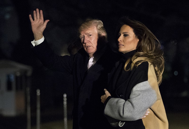 President Donald Trump with first lady Melania Trump waves as he returns to the White House in Washington, Monday, Jan. 15, 2018. Trump spent the holiday weekend at his Mar-a-Lago estate in Palm Beach, Fla. (AP Photo/Manuel Balce Ceneta)