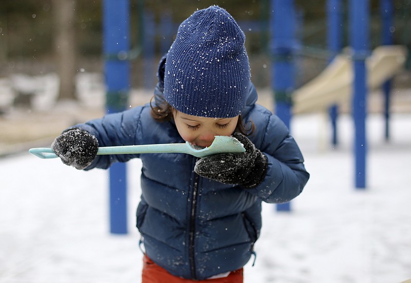 Four-year-old Jack Debenport [CQ] eats snow out of a toy shovel while playing at Riverview Park on Tuesday, Jan. 16, 2018 in Chattanooga, Tenn. Chattanooga experienced a light dusting of snow by late afternoon. The fear of inclement weather closed several area schools.