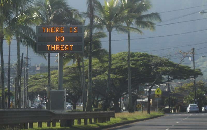 This Saturday, Jan. 13, 2018, photo provided by Jhune Liwanag shows a highway median sign broadcasting a message of "There is no threat" in Kaneohe, Hawaii. State emergency officials mistakenly sent out an emergency alert warning of an imminent missile strike, sending islanders into a panic. (Jhune Liwanag via The AP)