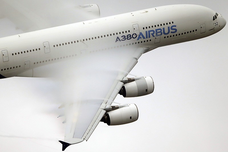 In this June 18, 2015, file photo, vapor forms across the wings of an Airbus A380 as it performs a demonstration flight at the Paris Air Show, Le Bourget airport, north of Paris. Airbus sAys it will stop making its costly A380 superjumbo if it can't strike a long-term deal with Emirates airline for a steady supply of the planes. (AP Photo/Francois Mori, File)