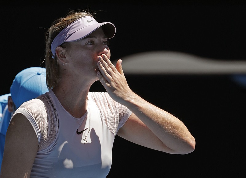 Russia's Maria Sharapova blows kisses to the crowd after she won over Germany's Tatjana Maria during their first round match at the Australian Open tennis championships in Melbourne, Australia, Tuesday, Jan. 16, 2018. (AP Photo/Vincent Thian)