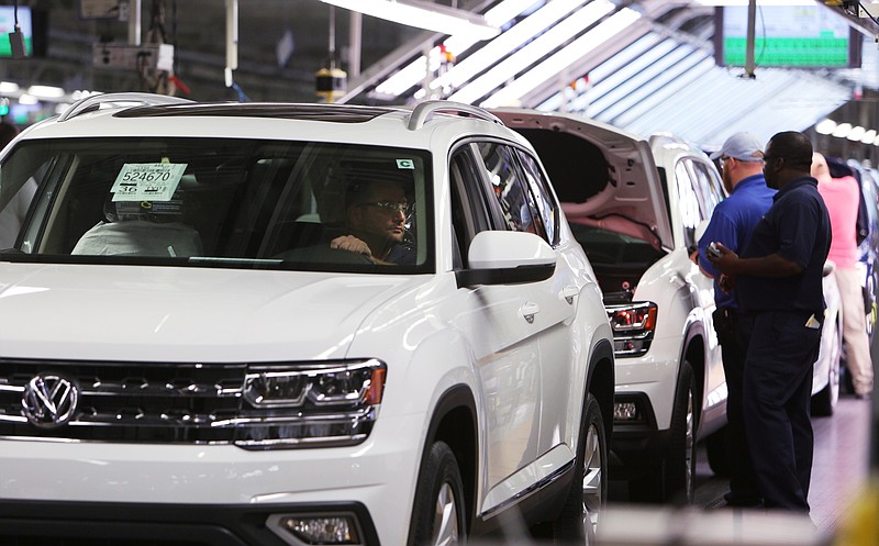 A Volkswagen employee checks out an Atlas SUV on the assembly line at the automaker's Chattanooga plant.