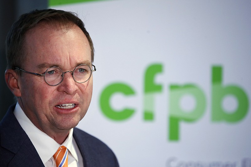 FILE - In this Monday, Nov. 27, 2017, file photo, Mick Mulvaney speaks during a news conference after his first day as acting director of the Consumer Financial Protection Bureau in Washington. Mulvaney said Wednesday, Jan. 17, 2018, that he is launching a review of all the federal consumer watchdog agency’s policies and priorities. (AP Photo/Jacquelyn Martin, File)