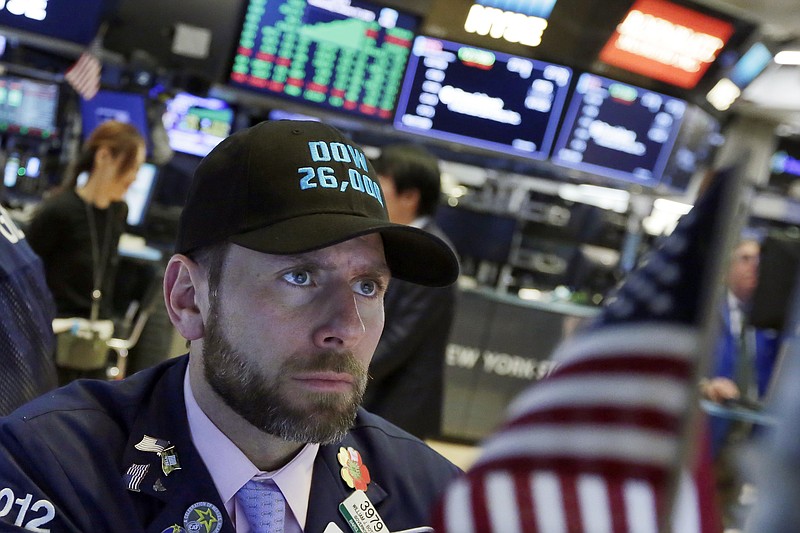 Specialist Michael Pistillo wears a "Dow 26,000" hat as he works on the floor of the New York Stock Exchange, Wednesday, Jan. 17, 2018. Stocks are closing higher on Wall Street, sending the DJIA to its first close above 26,000 points. (AP Photo/Richard Drew)