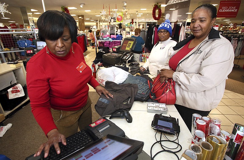 In this Tuesday, Dec. 26, 2017, file photo, J.C. Penney sales associate Wanda Cofield, left, assists Cynthia Putney, right, and Linda Pierce with returns and exchanges at the store, at Golden East Crossing mall in Rocky Mount, N.C. With the holiday season over, some shoppers are still wondering what to do with the unwanted gifts still hanging around. Shoppers have options, including swapping and selling online. (Alan Campbell/Rocky Mount Telegram via AP, File)