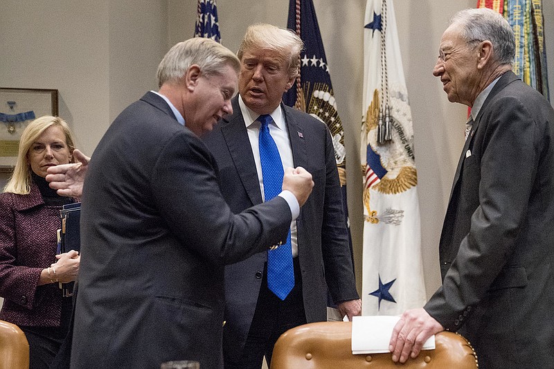 President Donald Trump greets Sen. Lindsey Graham, R-S.C., second from left, and Sen. Chuck Grassley, R-Iowa, right, as they meet to discuss immigration in the Roosevelt Room in the White House, Thursday, Jan. 4, 2018, in Washington. Also pictured is Secretary of Homeland Security Kirstjen Nielsen, left. (AP Photo/Andrew Harnik)