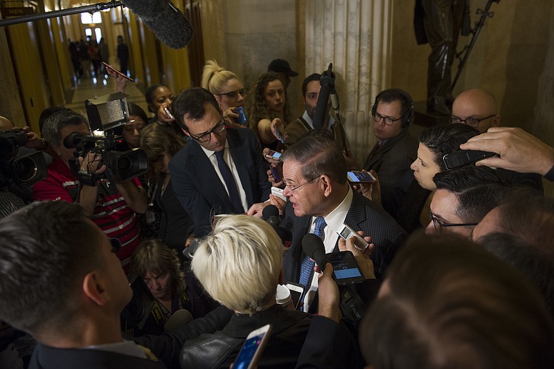 Sen. Robert Menedez, D-N.J., speaks with reporters after attending a Congressional Hispanic Caucus meeting with White House Chief of Staff John Kelly on Capitol Hill in Washington, Wednesday, Jan. 17, 2018. (AP Photo/Cliff Owen)