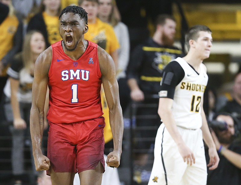 
              SMU guard Shake Milton celebrates a shot and a foul while Wichita State guard Austin Reaves can only watch during the second half of an NCAA college basketball game, Wednesday, Jan. 17, 2018 in Wichita, Kan. (Travis Heying/The Wichita Eagle via AP)
            