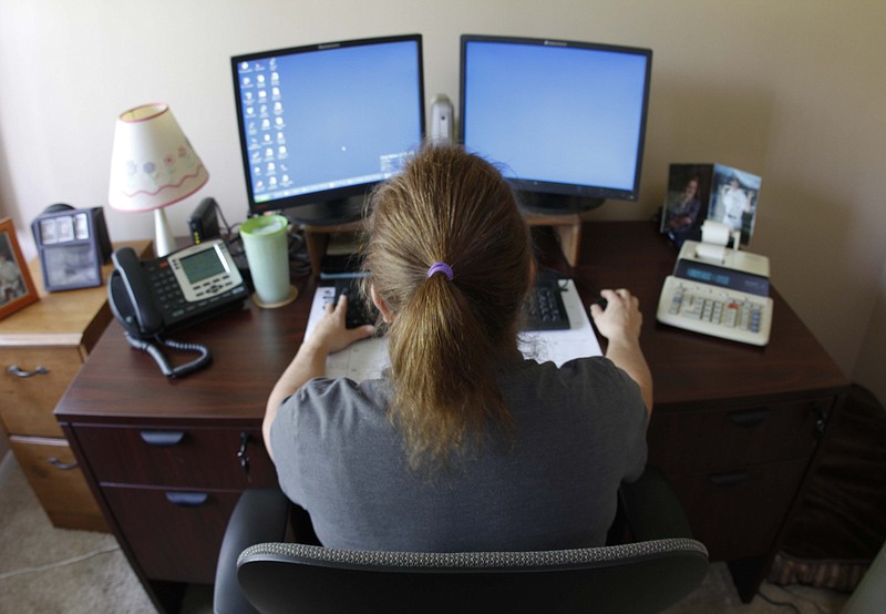 In this 2013 staff file photo, Tammy Payne, an employee at Blue Cross Blue Shield of Tennessee, telecommutes from her Flinstone, Ga., residence.