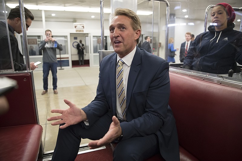 Sen. Jeff Flake, R-Ariz., talks to reporters just after a blistering speech on the Senate floor aimed at President Donald Trump, at the Capitol in Washington, Wednesday, Jan. 17, 2018.  In a speech on the Senate floor, Flake called Trump’s repeated attacks on the media “shameful” and “repulsive” and said Trump “has it precisely backward.’’ Flake said despotism is the enemy of the people, while a free press is the despot’s enemy and a guardian of democracy. (AP Photo/J. Scott Applewhite)