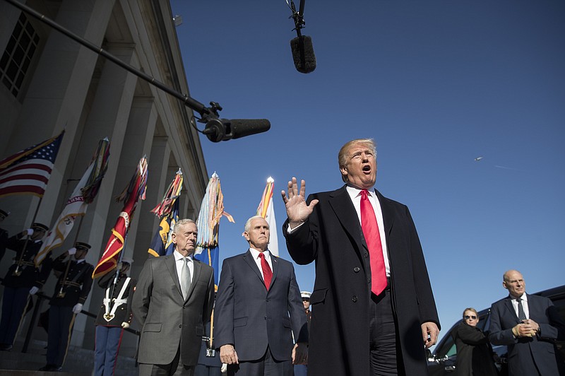 
              President Donald Trump, joined by Defense Secretary Jim Mattis, left, Vice President Mike Pence, second from left, and White House Chief of Staff John Kelly, right, speaks to the media as he arrives at the Pentagon, Thursday, Jan. 18, 2018. (AP Photo/Carolyn Kaster)
            