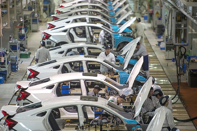 
              In this Feb. 6, 2017 photo, workers assemble Honda Civics on an assembly line at a Dongfeng Honda automotive plant in Wuhan in central China's Hubei province. China’s economy expanded at a 6.9 percent pace in 2017, faster than expected and the first annual increase in seven years, the government reported Thursday, Jan. 18, 2018. (Chinatopix via AP)
            