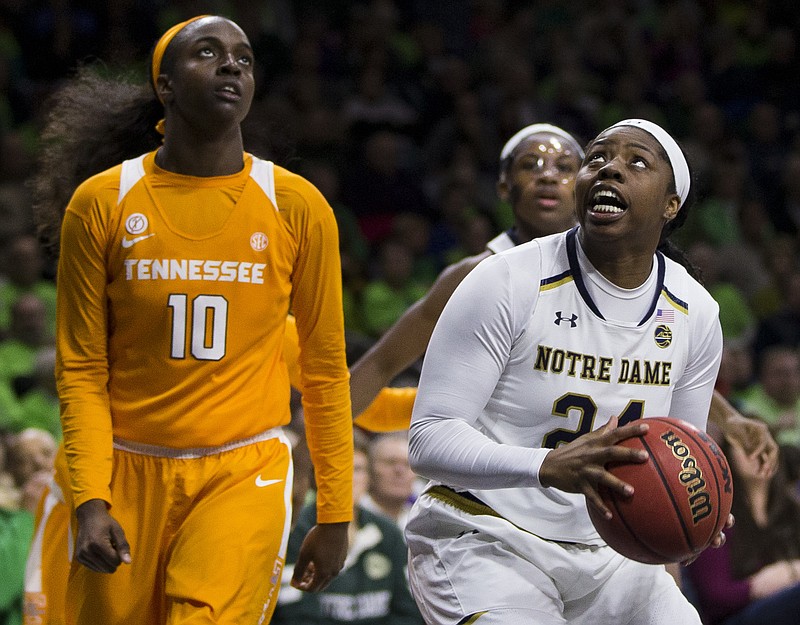 Notre Dame's Arike Ogunbowale (24) looks to shoot under the basket next to Tennessee's Meme Jackson (10) during the second half of an NCAA college basketball game Thursday, Jan. 18, 2018, in South Bend, Ind. (AP Photo/Robert Franklin)