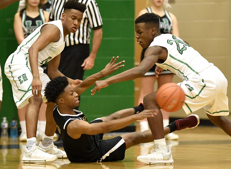 Tyner's Michael Little (5) passes from the floor as East Hamilton's Vandrele Wilson (0) and Kyler Johnson (2) apply pressure.  The Tyner Rams visited the East Hamilton Hurricanes in TSSAA basketball action on January 19, 2018.