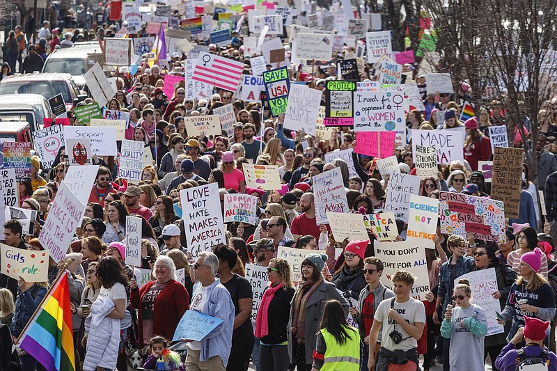 Demonstrators crowd Broad Street in front of the Tennessee Aquarium during the Chattanooga Women's March on Saturday, Jan. 20, 2018, in Chattanooga, Tenn. Thousands of demonstrators gathered at Coolidge Park and marched across the Market Street Bridge through the city's tourist district to show solidarity with a national women's rights movement.