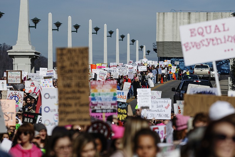 Demonstrators march on Market Street during the Chattanooga Women's March on Saturday, Jan. 20, 2018, in Chattanooga, Tenn. Thousands of demonstrators gathered at Coolidge Park and marched across the Market Street Bridge through the city's tourist district to show solidarity with a national women's rights movement.