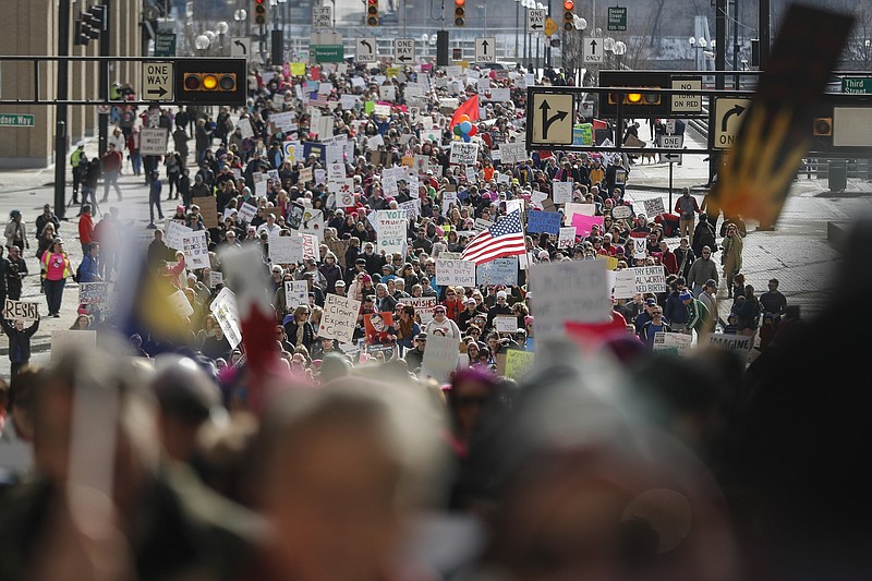 Protestors participate in a Women's March highlighting demands for equal rights and equality for women, Saturday, Jan. 20, 2018, in Cincinnati.