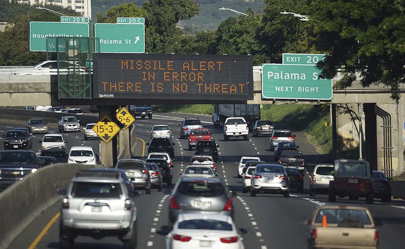 FILE - Vehicles drive past a highway sign that says "MISSILE ALERT ERROR THERE IS NO THREAT" on the H-1 Freeway in Honolulu on Jan. 13. Gov. David Ige appointed state Army National Guard Brig. Gen. Kenneth Hara as new head of Hawaii's emergency management agency after a faulty alert was sent to cellphones around the state warning of an incoming missile attack. (Cory Lum/Civil Beat via AP, file)
