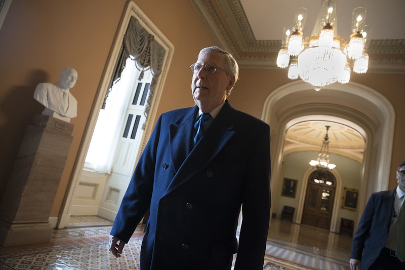 Senate Majority Leader Mitch McConnell, R-Ky., returns to his office as the federal shutdown enters Day 2 amid a partisan blame game on both sides, at the Capitol in Washington, Sunday, Jan. 21, 2018. (AP Photo/J. Scott Applewhite)