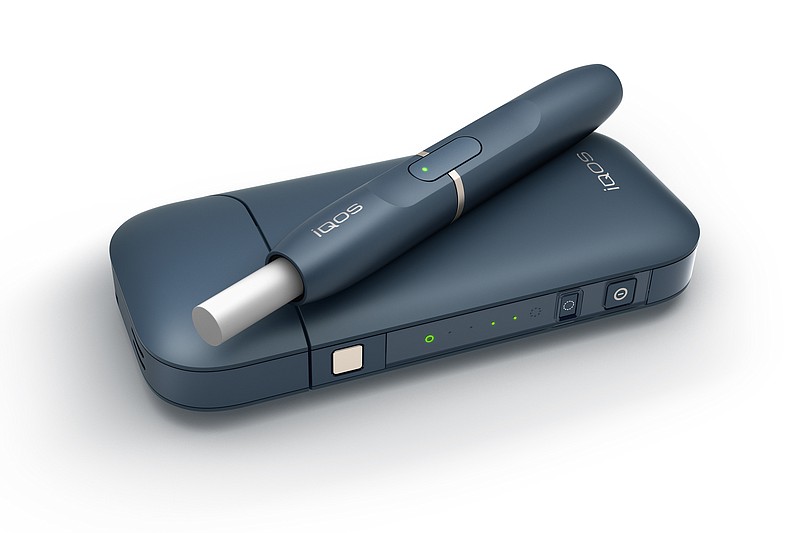 This undated image provided by Philip Morris in January 2018 shows the company's iQOS product. The device heats tobacco sticks but stops short of burning them, an approach that Philip Morris says reduces exposure to tar and other toxic byproducts of burning cigarettes. This is different from e-cigarettes, which don’t use tobacco at all but instead vaporize liquid usually containing nicotine. (Philip Morris via AP)