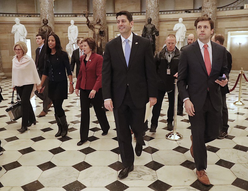 House Speaker Paul Ryan of Wis., center, walks with other members of Congress to the House Chamber on Capitol Hill in Washington, Monday, Jan. 22, 2018, to begin a vote on a short term spending bill to reopen the government. (AP Photo/Pablo Martinez Monsivais)