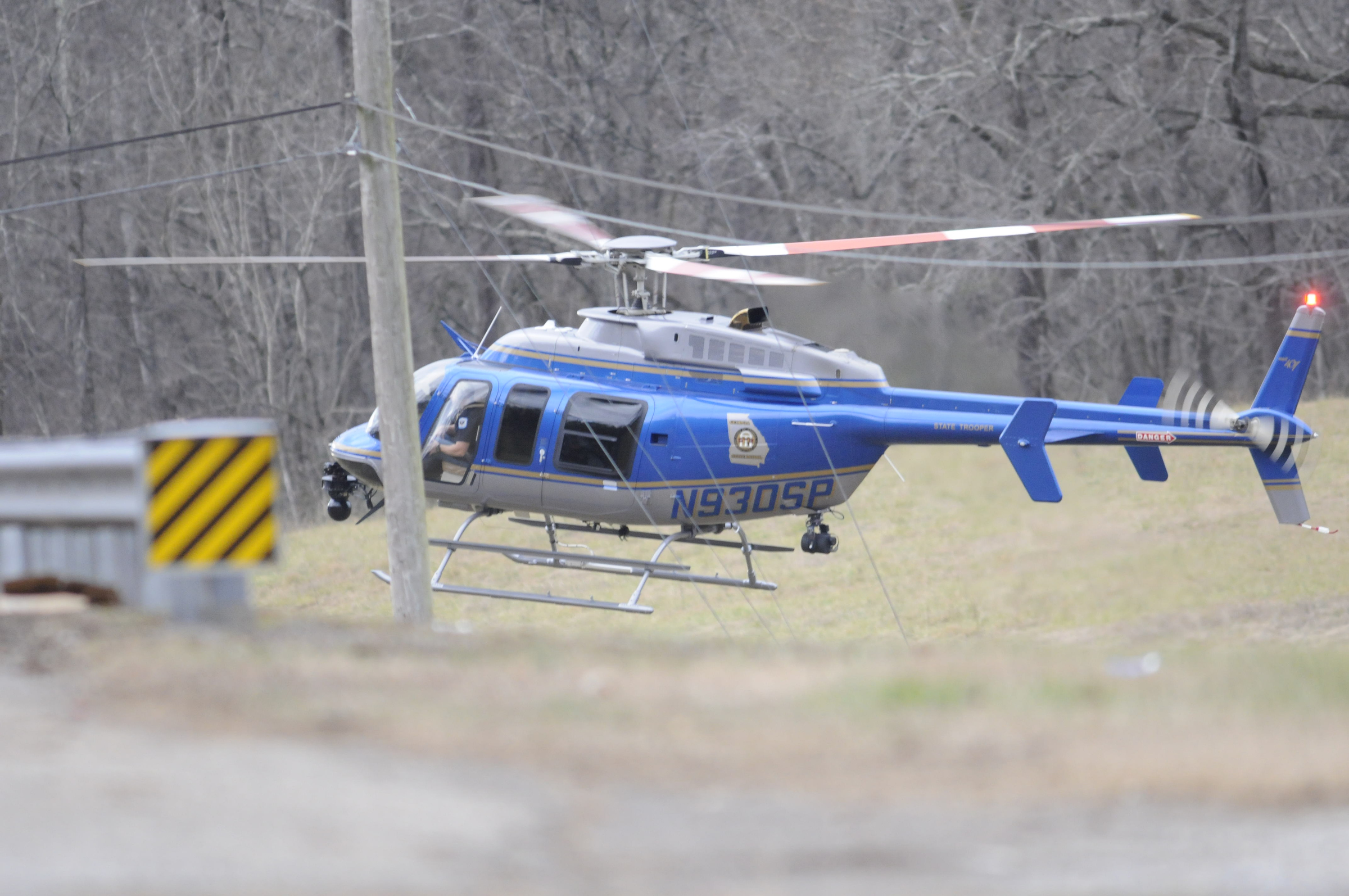 Multiple law enforcement agencies, including this helicopter from the Georgia State Patrol, search for a man near Whitwell late Tuesday.