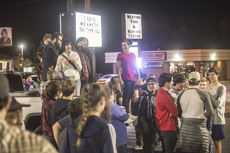 Dozens gathered in a nearby parking lot for a candlelight vigil for a damaged Taco Bell in Montgomery, Ala., on Sunday, Jan. 21, 2018. (Shannon Heupel/The Montgomery Advertiser via AP)