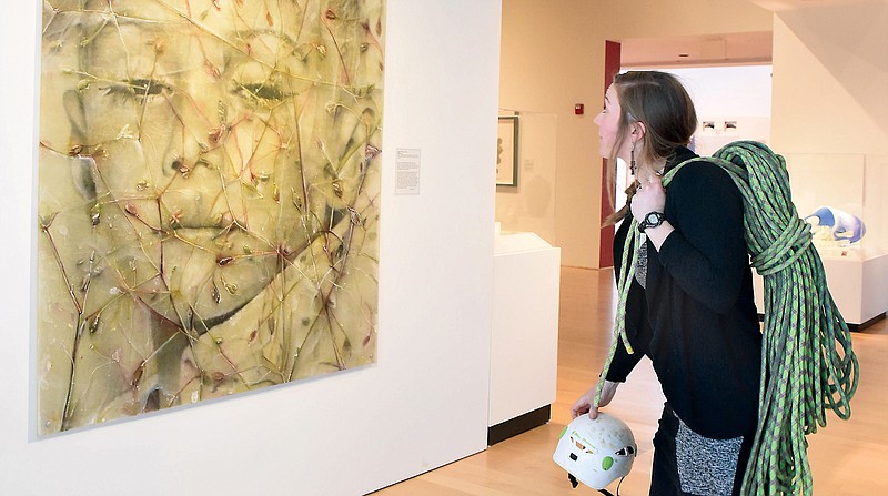 Chelsea Higgins,  a local climber and education coordinator at the Hunter Museum, stands in front of Sibylle Peretti's "Victor."