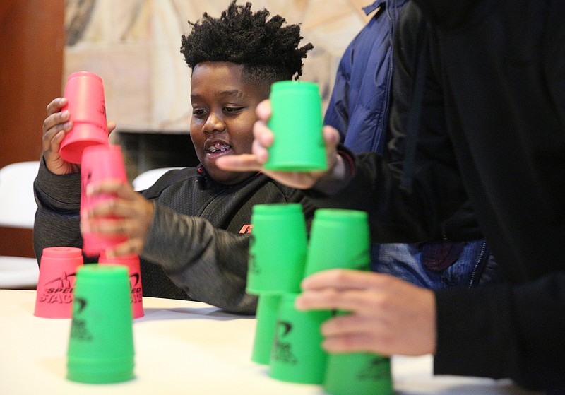 Keylon Crayton, 12, plays a cup stacking game during a grief camp event Friday, Jan. 5, 2018 at Booker T. Washington State Park in Chattanooga, Tenn. The East Chattanooga Improvement Inc. hosted the grief camp for youth who have lost a relative to death or divorce.