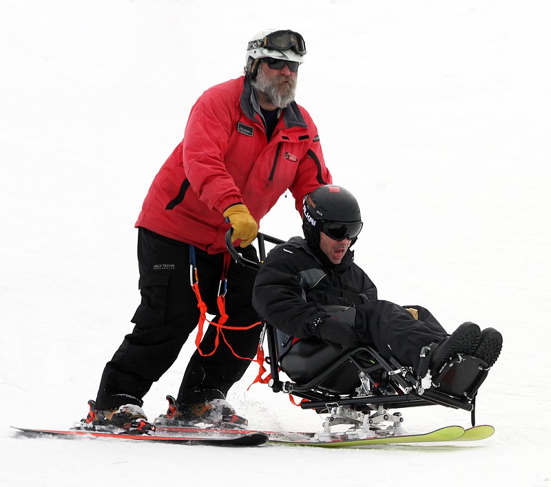Chris Werkane of Adaptive Adventures guides disabled Cleveland, Tenn., resident and former Thunderbirds pilot Shawn Pederson down a slope at Beech Mountain last week.