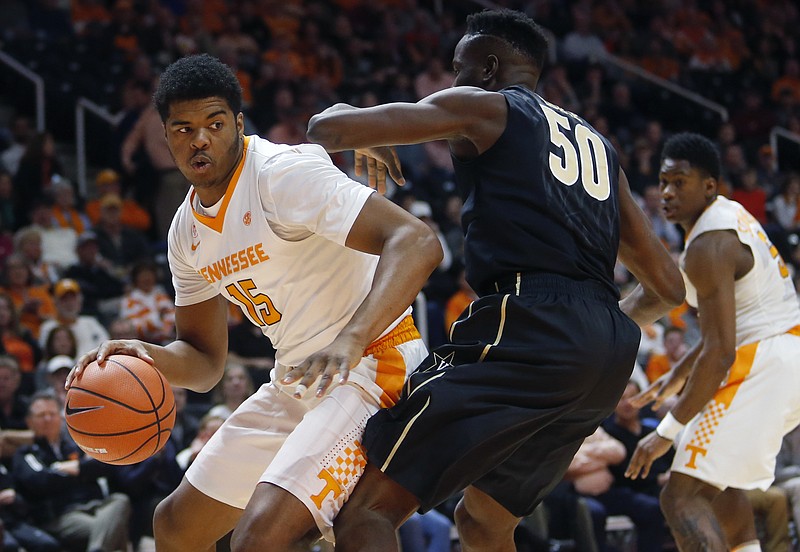 Tennessee freshman forward Derrick Walker works his way toward the basket while guarded by Vanderbilt forward Ejike Obinna during Tuesday night's game in Knoxville. Walker's contributions have increased the past two games.