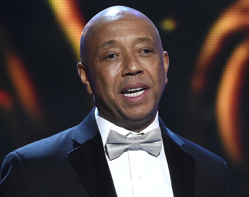 In this Feb. 6, 2015, file photo, hip-hop mogul Russell Simmons presents the Vanguard Award on stage at the 46th NAACP Image Awards in Pasadena, Calif. A Los Angeles woman is suing Simmons, alleging he raped her at his home in 2016. An attorney for 37-year-old Jennifer Jarosik filed the lawsuit Wednesday, Jan. 24, 2018. (Photo by Chris Pizzello/Invision/AP, File)