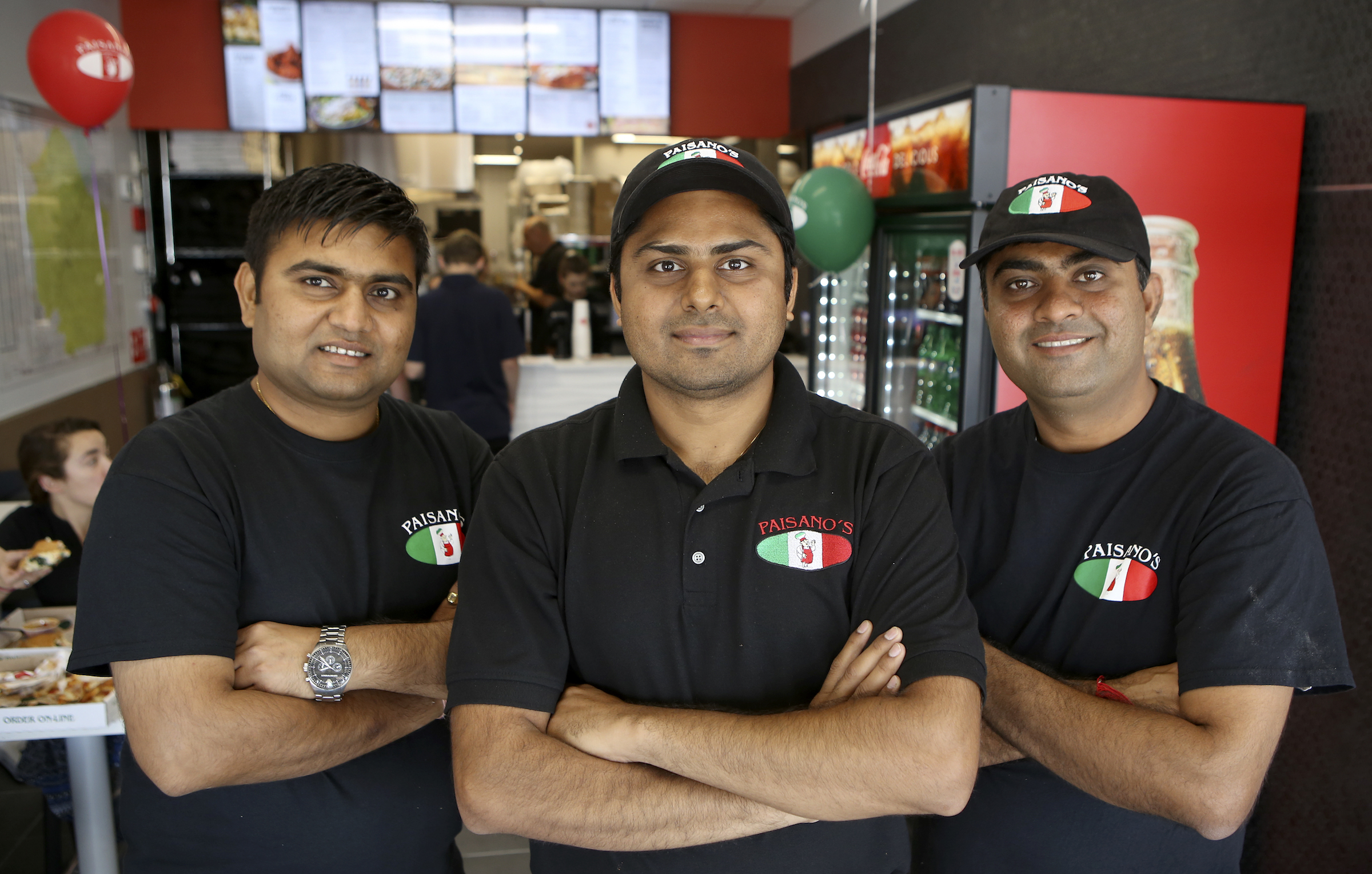 Franchise partners Pratik {CQ} Patel, left, P.J. Patel and Nick Patel pose at Paisano's Pizza on Monday, Sept. 18, in Chattanooga, Tenn.