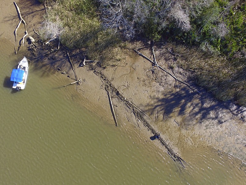 This aerial photo taken Tuesday, Jan. 2, 2018, in Mobile County, Ala., shows the remains of a ship that could be the Clotilda, the last slave ship documented to have delivered captive Africans to the United States. The Clotilda was burned after docking in Mobile, Ala., in 1860, long after the importation of humans was banned, and experts say the remains found by a reporter from Al.com could be what is left of the long-lost wreck. (Ben Raines/Al.com via AP)