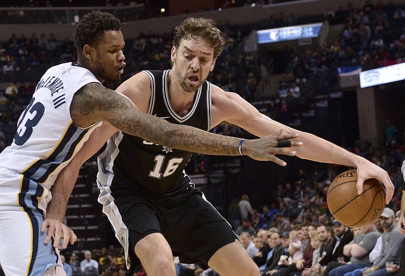 San Antonio Spurs center Pau Gasol (16) controls the ball against Memphis Grizzlies guard Ben McLemore (23) during the second half of an NBA basketball game Wednesday, Jan. 24, 2018, in Memphis, Tenn. (AP Photo/Brandon Dill)