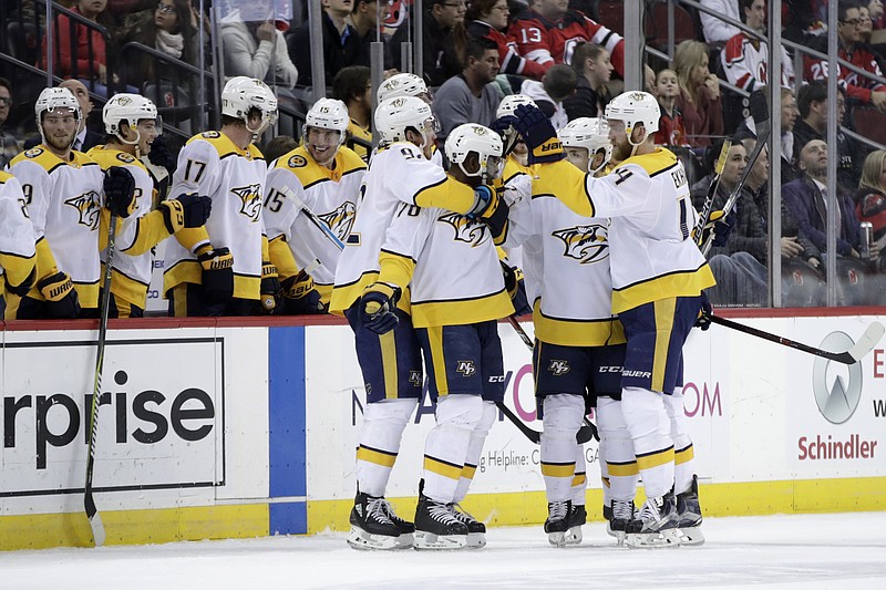 Nashville Predators players celebrate a goal by defenseman P.K. Subban (76) during the second period of an NHL hockey game against the New Jersey Devils, Thursday, Jan. 25, 2018, in Newark, N.J. (AP Photo/Julio Cortez)