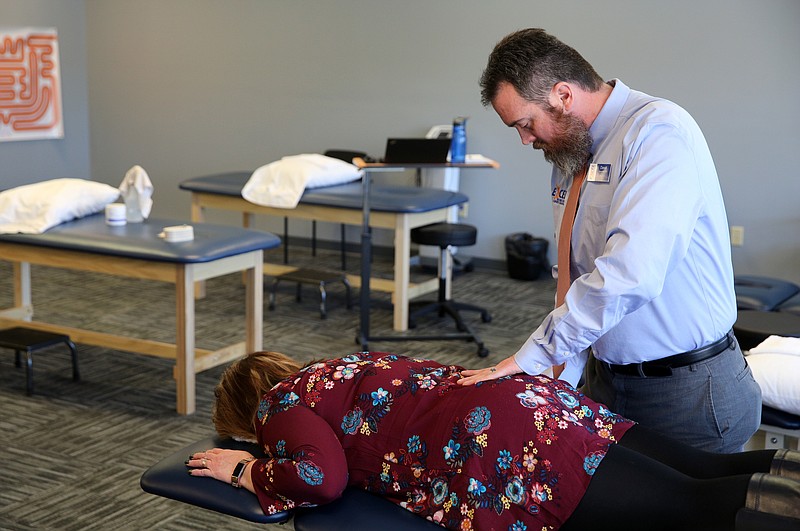 David Brackett, the clinical director at Excel Rehab and Sports, demonstrates a lumbar mobilization technique on Susan Henson that he uses to help loosen up soreness a client may have Tuesday, Jan. 23, 2018 at Excel Rehab and Sports in the 2 North Shore shopping center in Chattanooga, Tenn. Brackett says Excel Rehab and Sports uses a hands on approach and teaches clients the stretches and exercises they need to get them back to their normal routines as quickly as possible. 