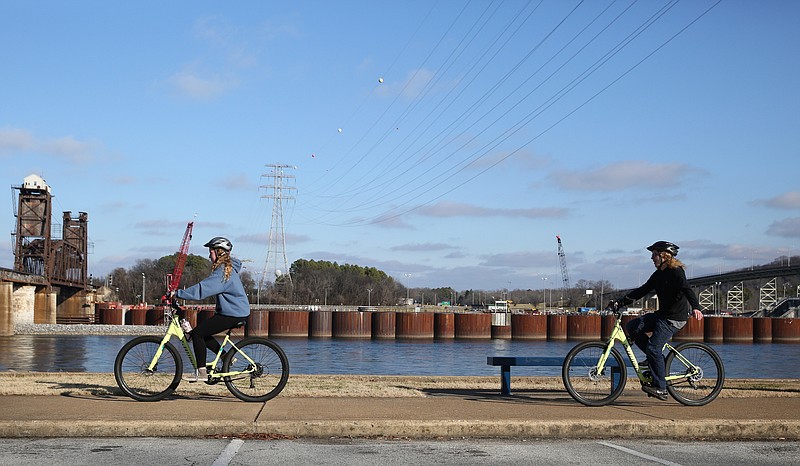Ivy Academy students Zoe Dayhuff and Jonathan Harvey ride bikes with their classmates along the Tennessee Riverpark Wednesday, Jan. 24, 2018 in Chattanooga, Tenn. Outdoor Chattanooga partnered with Ivy Academy for students to conduct a field study along the riverwalk.
