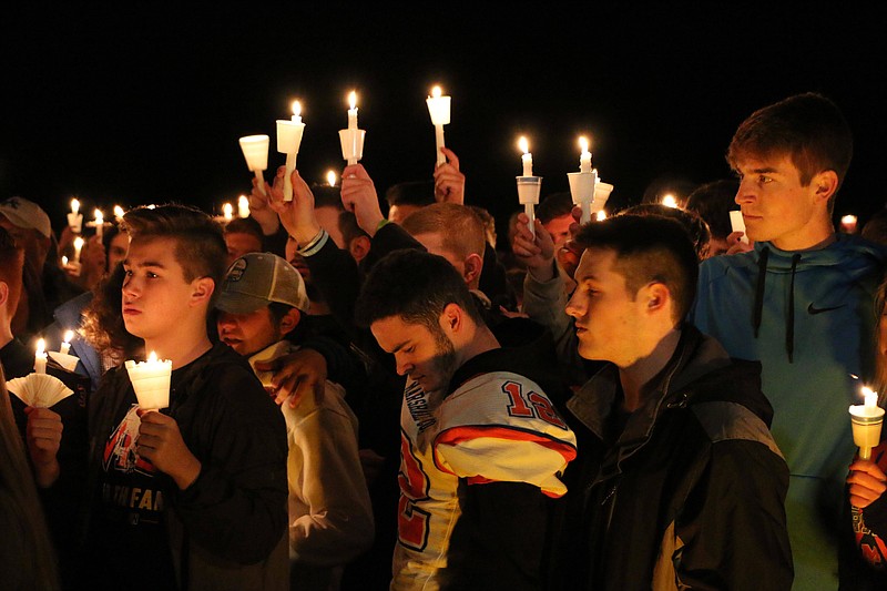 People attend a vigil for the victims of a fatal shooting at Marshall County High School on Thursday, Jan. 25, 2018, at Mike Miller County Park in Benton, Ky. The 15-year-old accused of the fatal shooting on Tuesday, which left over a dozen injured, was ordered held Thursday on preliminary charges of murder and assault. (AP Photo/Robert Ray)