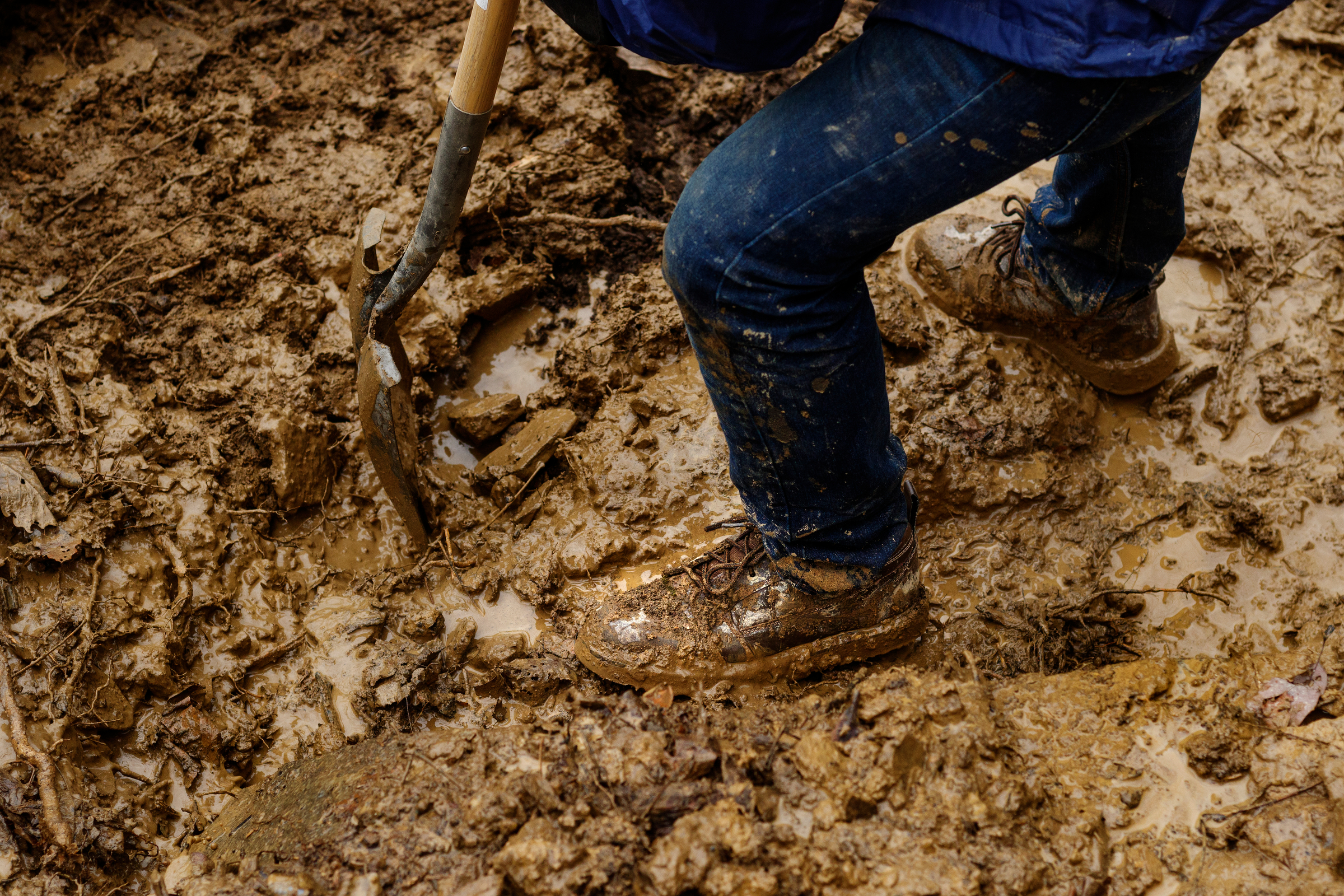 A volunteer is covered in mud while clearing the TTC Gravity Park trail on Saturday, Jan. 27, 2018, in Sequatchie, Tenn. Volunteers are working to reopen the downhill mountain biking trail which features 1,000 feet of elevation change on a challenging course.