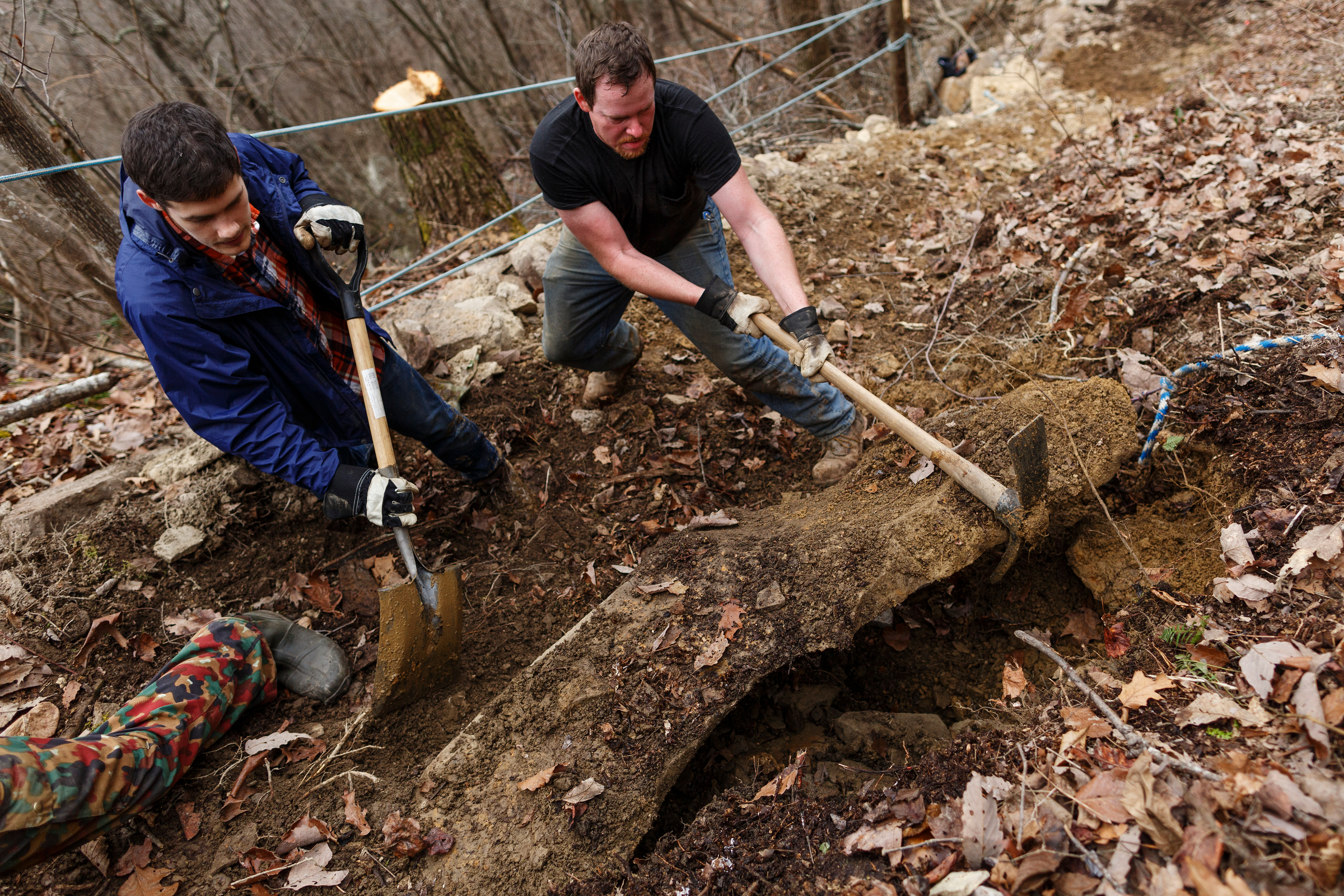 Logan Gross, left, and Ben Young remove a rock while clearing the TTC Gravity Park trail on Saturday, Jan. 27, 2018, in Sequatchie, Tenn. Volunteers are working to reopen the downhill mountain biking trail which features 1,000 feet of elevation change on a challenging course.