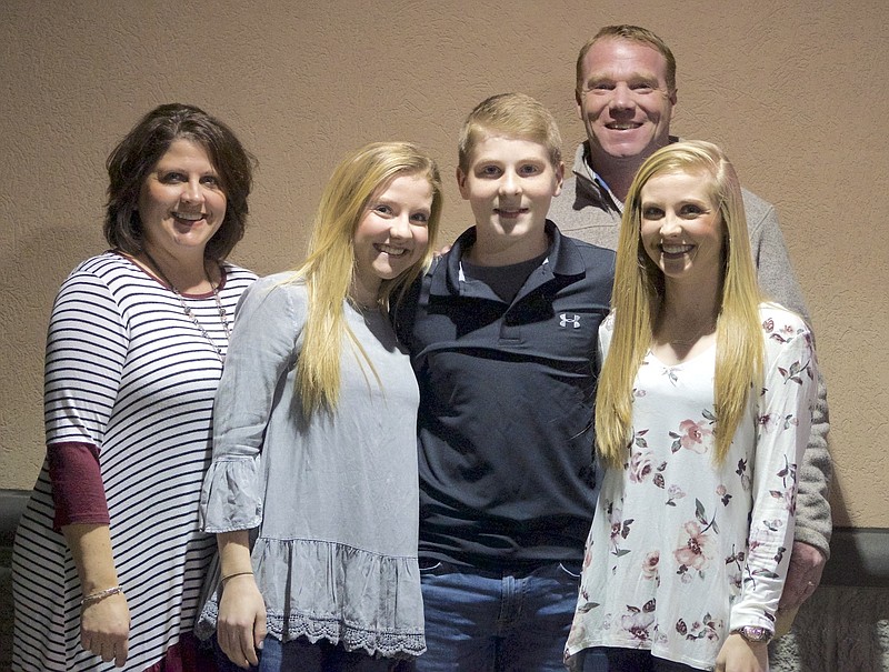 In this undated photo Carter Davison poses for a photo with his family at Beef O'Brady's in Elizabethton, Tenn. Davison made history at Lonesome Pine Raceway in 2017. (Jeff Birchfield/The Johnson City Press via AP)