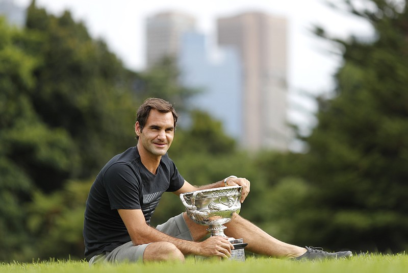 Roger Federer poses with the Norman Brookes Challenge Cup on Monday in Melbourne, Australia, after winning the men's singles final at the Australian Open against Marin Cilic on Sunday.