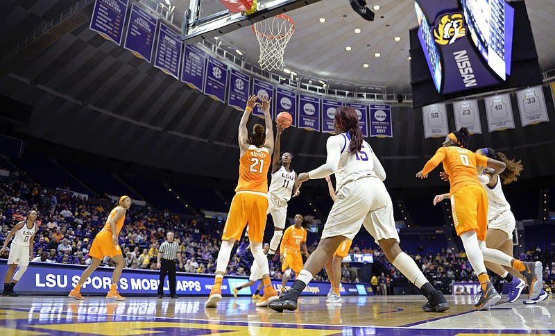 LSU guard Raigyne Louis (11) puts the ball up for two points as Tennessee center Mercedes Russell (21) defends in the first half of an NCAA college basketball game, Sunday, Jan. 28, 2018, in Baton Rouge, La. (AP Photo/Bill Feig)
