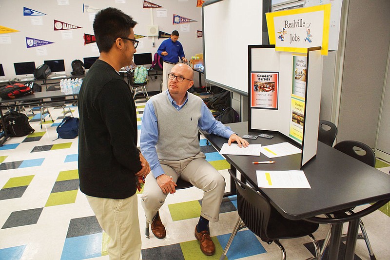 A student and volunteer participate in Reality Check.