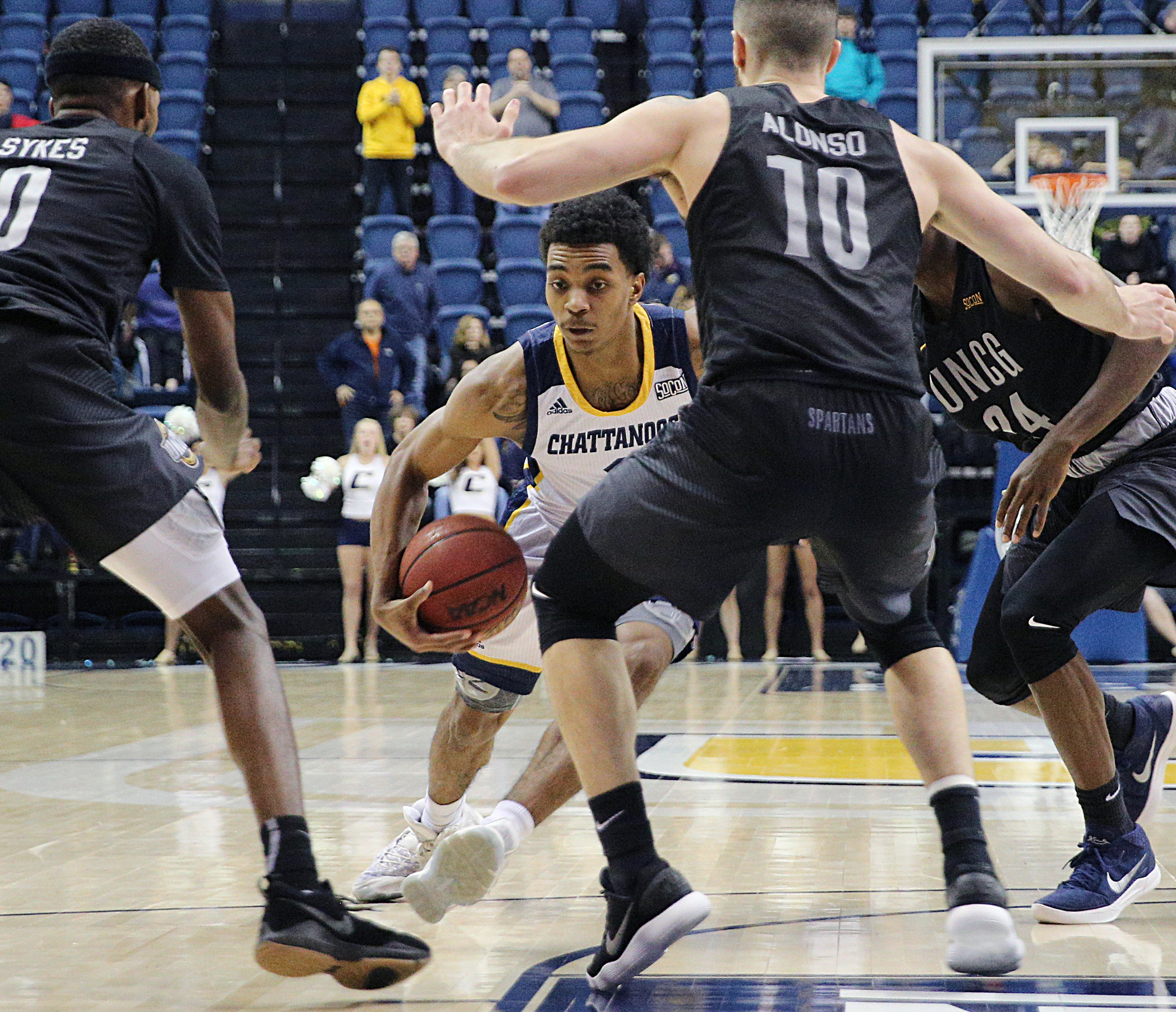 University of Tennessee at Chattanooga's Rodney Chatman (1) draws a foul to UTC a shot at winning in double overtime against University of North Carolina Greensboro men's basketball game Monday, Jan. 29, 2018 at McKenzie Arena at UTC in Chattanooga, Tenn.