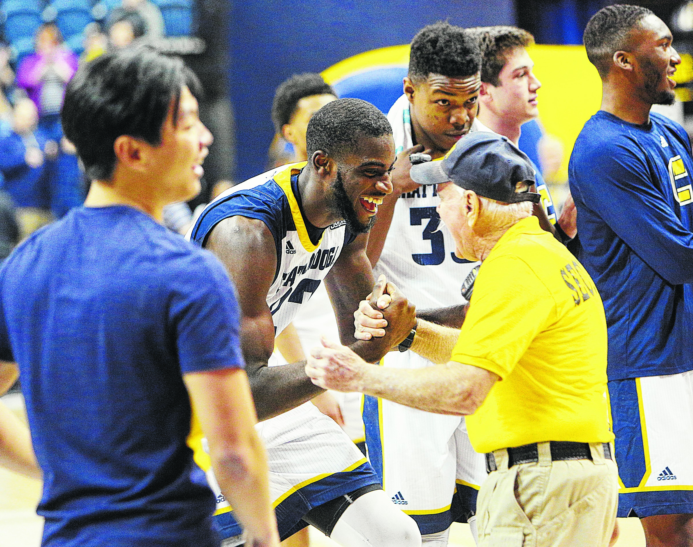 University of Tennessee at Chattanooga's Makinde London (22) celebrates with a UTC security official following the UTC vs. University of North Carolina Greensboro men's basketball game Monday, Jan. 29, 2018 at McKenzie Arena at UTC in Chattanooga, Tenn.