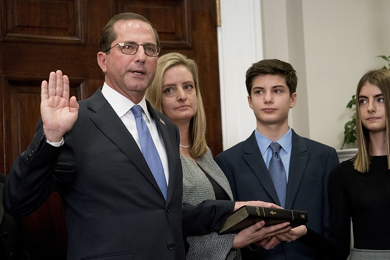 Health and Human Services Secretary Alex Azar, left, accompanied by his family, is sworn in during a ceremony in the Roosevelt Room at the White House, Monday, Jan. 29, 2018, in Washington. (AP Photo/Andrew Harnik)
